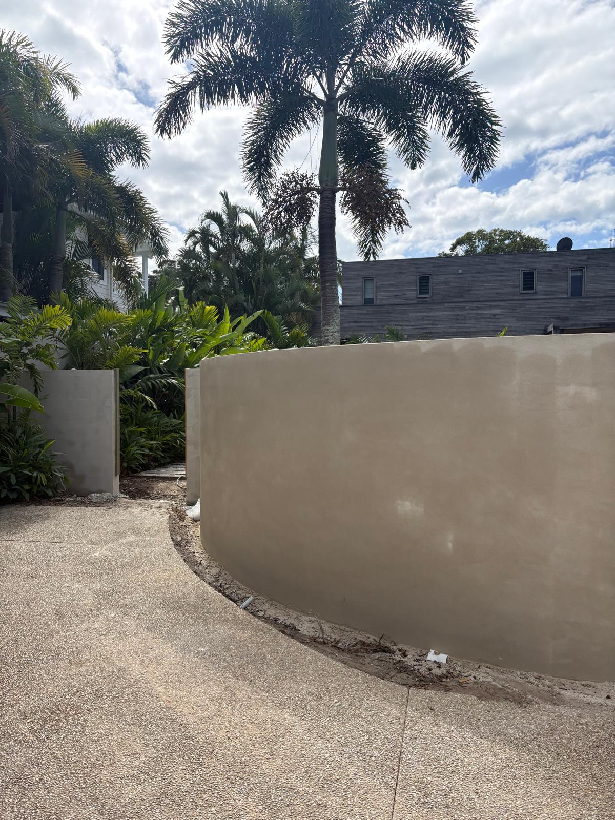 Curved rendered garden wall leading to the entry at 17 Marvel Street