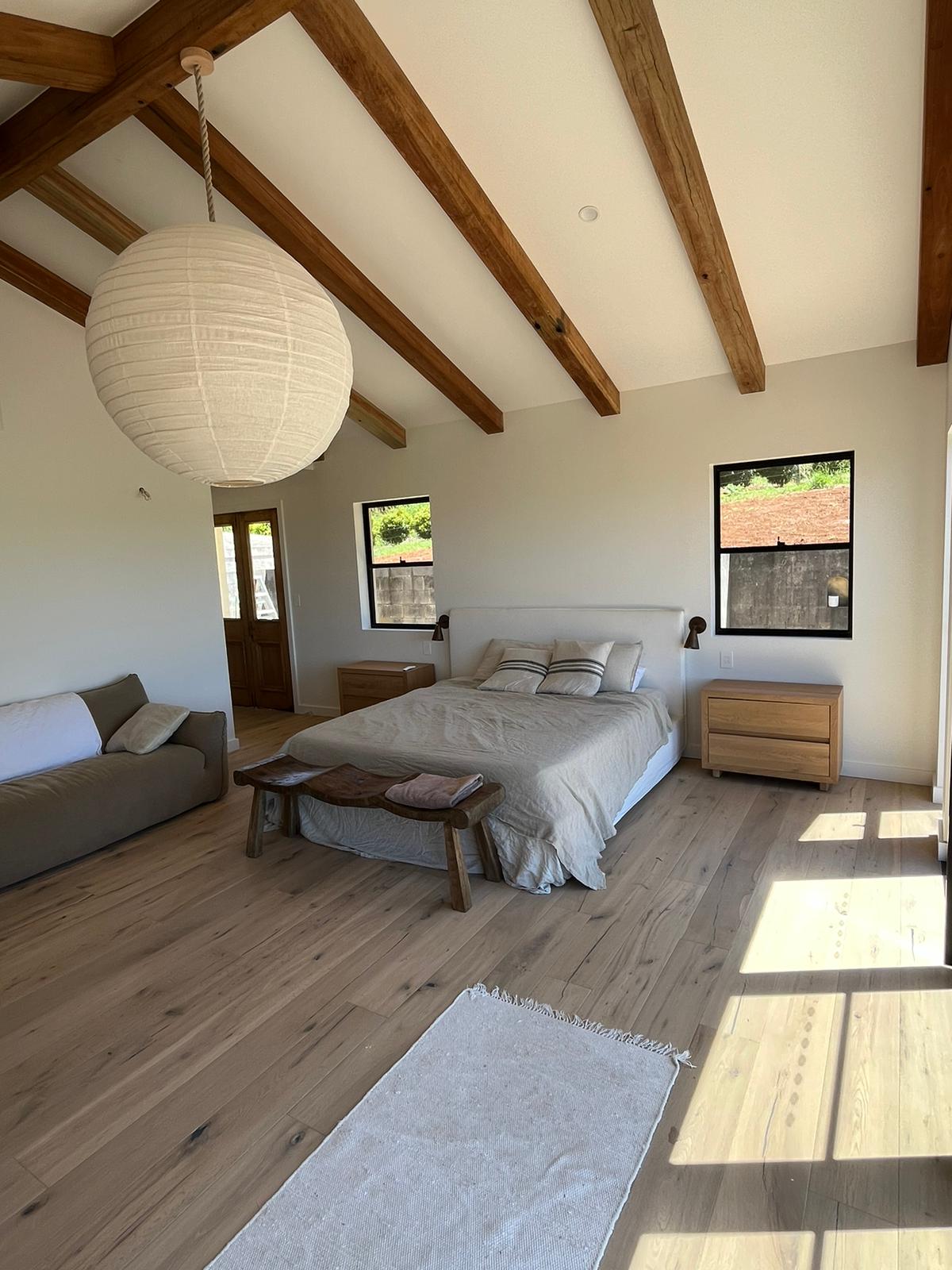 Primary bedroom with vaulted ceilings and ocean views at Newrybar