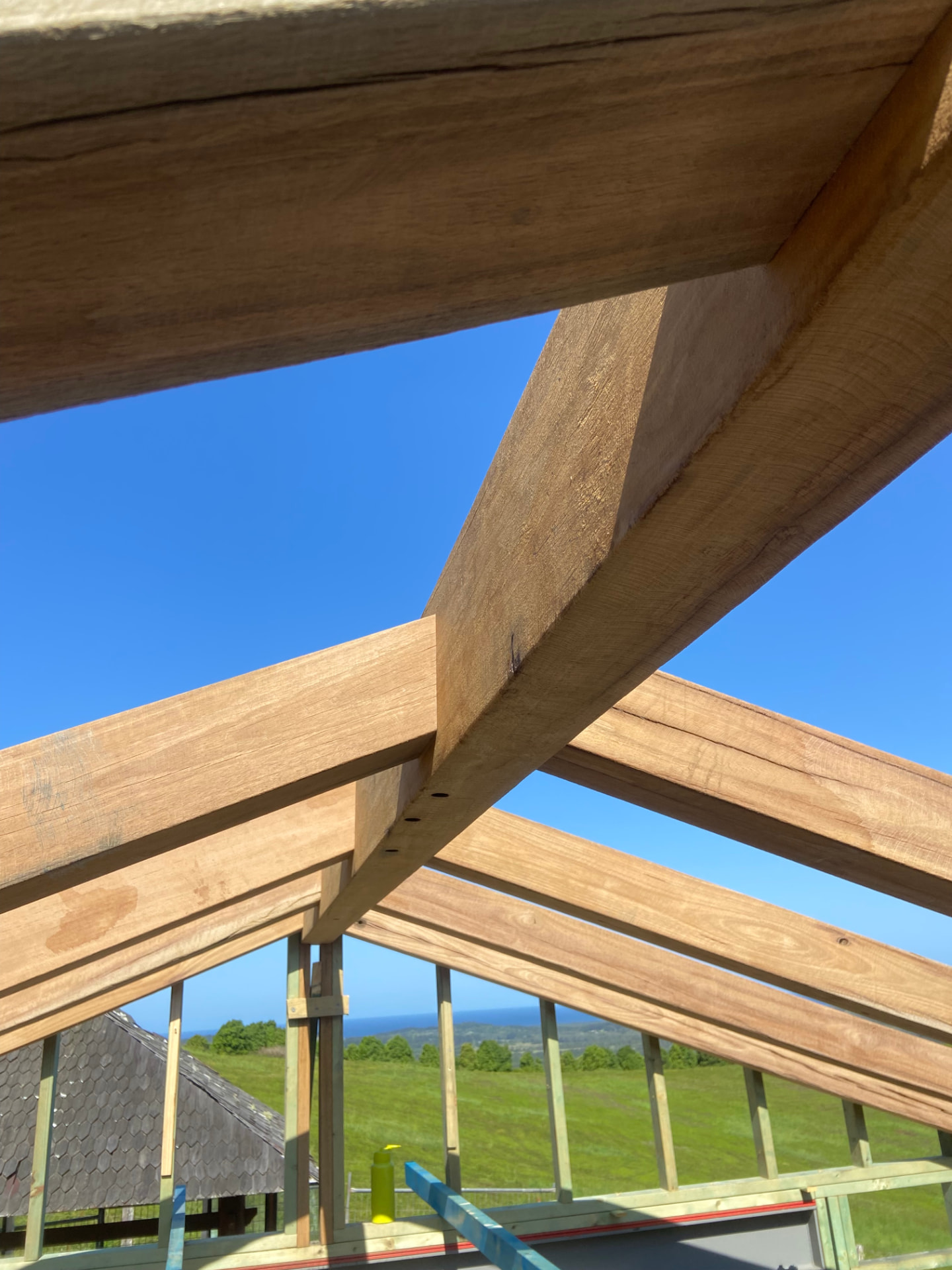 Hardwood roof truss joinery against a clear sky