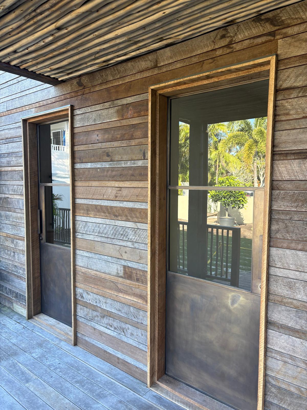 17 Marvel Street — Reclaimed hardwood cladding with blackened steel doors
